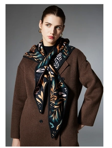 Close-up of leaf pattern jacquard shawl paired with a dark brown wool coat
