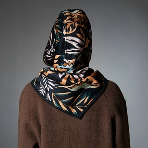 French style hooded balaclava scarf with cashew flower print worn on brown coat