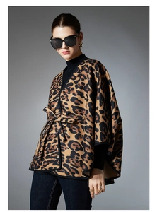Detail of leopard print shawl cape with waist belt tie and batwing sleeves for women