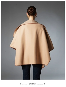 Detail of the elegant camel shawl with contrast dark brown piping and soft wool fabric texture