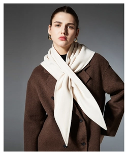Detail of elegant cream fleece triangle scarf with a simple cross-over style for women