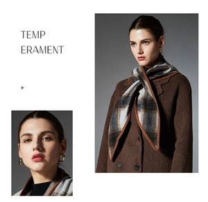 Detail of wool plaid scarf with brown contrast borders and knitted texture