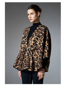 Detailed view of women's leopard print shawl with adjustable waist belt and edge binding