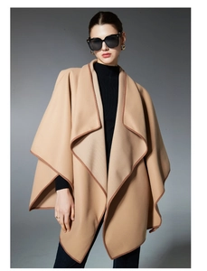 Close-up of elegant camel shawl with contrast dark brown piping and soft texture