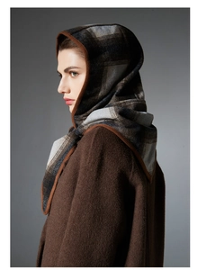 Close-up of winter wool balaclava shawl with classic grey plaid pattern and brown trim