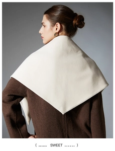 Detail view of cream white triangle shawl showing fine knit texture and edge stitching