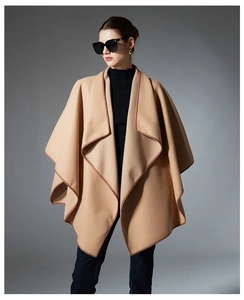 Detail view of khaki shawl cape with premium binding and elegant oversized lapel design