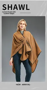 Detail of camel shawl with black leather trim and asymmetrical crossover front design