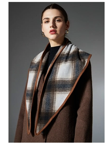 Close-up of classic brown and blue plaid wool shawl with premium hemmed edge detail