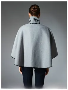 Detail view of grey wool cape scarf with elegant black scalloped edge stitching on back