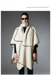 Close-up of cream white cape with black blanket stitch and matching thick neck warmer