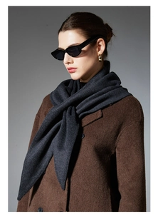 Close-up of thick dark grey wool scarf texture with dark brown coat and sunglasses