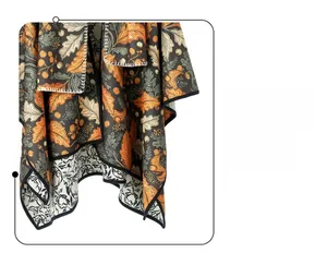 Detail of double-sided shawl featuring autumn maple leaves and black white floral prints
