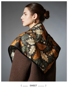 Detail of autumn leaf print scarf paired with a brown wool coat and golden hoop earrings