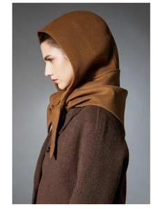 Detail of premium brown balaclava hood with long ties in warm cashmere texture