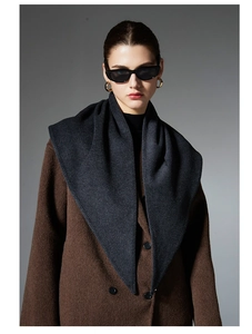 Detail of dark grey triangle scarf draped over a double-breasted wool coat for women