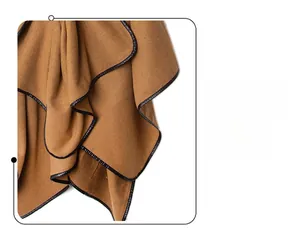 Detailed close-up of brown twill fabric with premium black leather-like bound edge finish