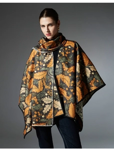 Detail of autumn leaf print shawl featuring maple patterns and white hand-stitched edges