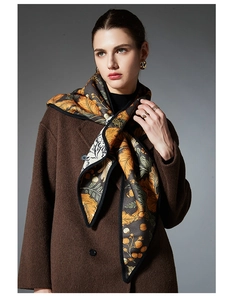 Detail of floral triangular shawl with leaf pattern styled on brown wool coat