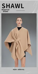 Detail of camel sleeveless shawl with diagonal buckle knot and elegant draped folds