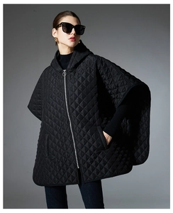 Detail view of black quilted hooded cape featuring a classic diamond pattern and silver zipper