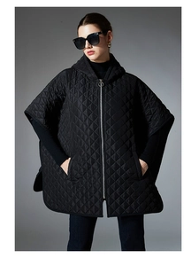 Detail of black quilted poncho with diamond stitching and circular ring zipper puller