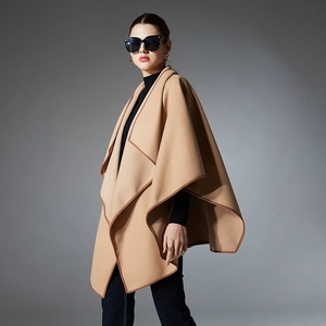 Elegant camel wool poncho for women with brown contrast piping and irregular hem design