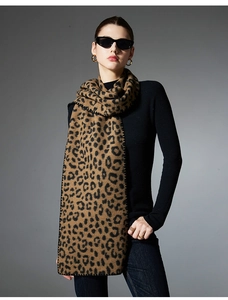 Close-up detail of leopard print scarf featuring refined black lock-edge stitching finish
