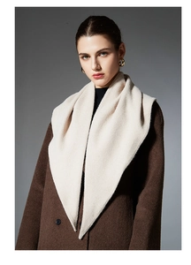 Detail showing the thick cashmere-like texture and weave of the cream triangle shawl scarf