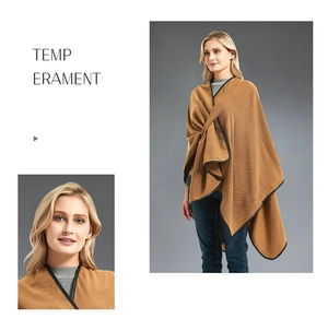 Detail of camel brown poncho cloak with black leather trim and elegant drape design