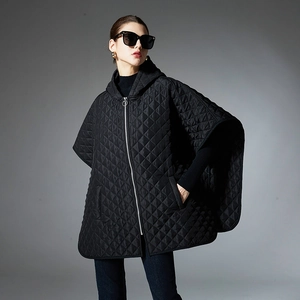 Women's black quilted hooded cape jacket with metal zipper and modern diamond pattern