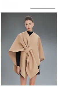 Close-up of elegant camel sleeveless cape featuring a unique front-tie knot detail