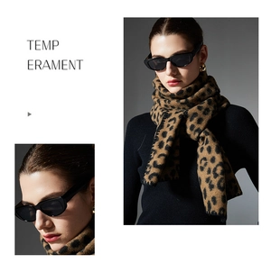 Close-up detail of soft leopard print scarf with whipstitch edges for autumn winter fashion