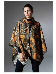 Detail view of the floral leaf print and ivory stitching on a reversible hooded shawl