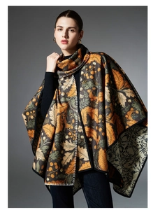 Detail showing autumn leaf patterns and white stitching on this reversible floral shawl