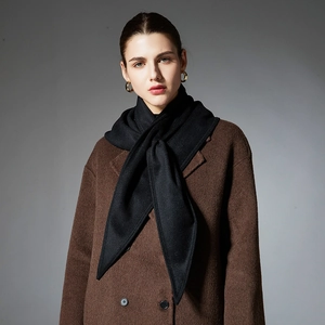 Elegant solid black winter triangle scarf wrap styled on a premium brown wool overcoat