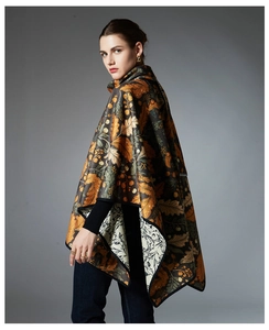 Detail view of double-sided knit shawl with autumn leaves and floral patterns in warm tones