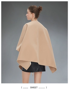Detail of the high-quality camel wool fabric and draped silhouette of this autumn cape