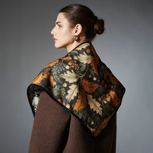 Elegant autumn oak leaf print shawl scarf draped over a brown winter coat