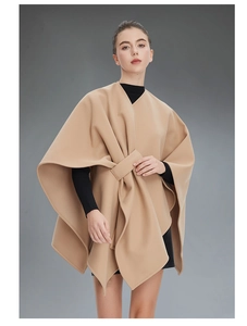 Detail of camel wool poncho shawl with unique front buckle knot and soft pleated texture