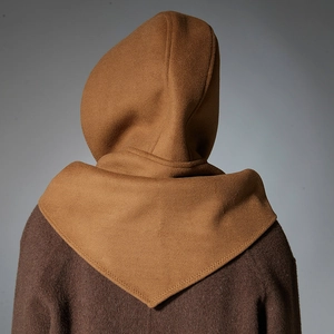 Caramel hooded balaclava scarf capelet shown on model back against grey studio background