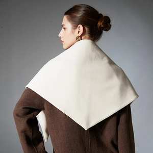 Elegant off-white cashmere shawl scarf styled on a dark brown wool coat for winter fashion