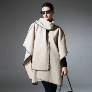 Elegant cream wool poncho with black blanket stitch trim for women's winter fashion