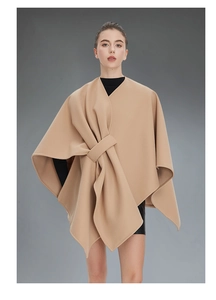 Detail view of camel wool shawl wrap with elegant front buckle and textured drape