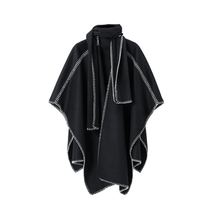 Elegant black knit poncho cape for women with contrasting white whipstitch edge detailing