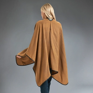 Women's knit poncho cape in camel with black faux leather trim and elegant draped silhouette