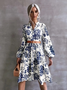 Elegant long sleeve floral midi dress with V-neck and brown leather belt on model