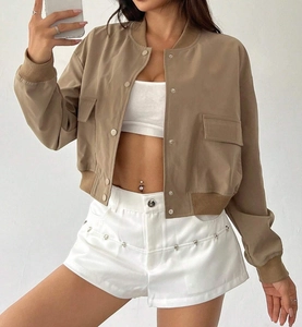 Detail of khaki cropped bomber jacket featuring stand collar and large flap pockets