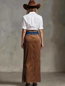 Back view of western cowboy outfit with white crop shirt and brown suede fringe skirt