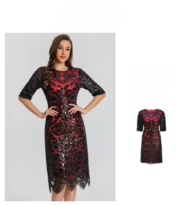 Detail of red and black sequined dress with handmade beadwork and floral lace embroidery